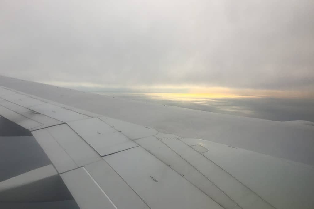 gray wing of airplane seen from mid-flight