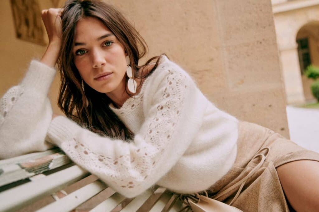 woman wearing sezane earrings with white sweater