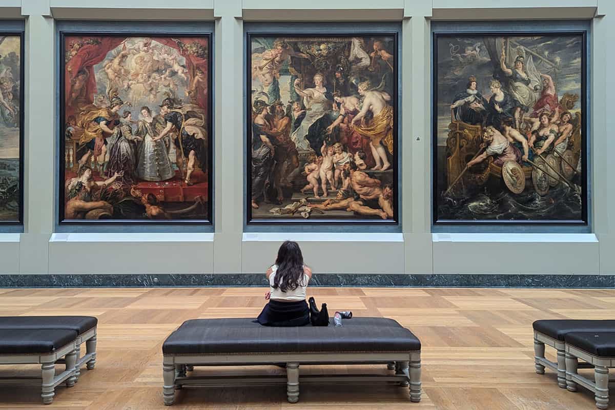 paris 1 day itinerary - girl sitting in the louvre