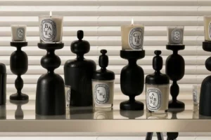 array of candles on wood stands - best diptyque candles for men