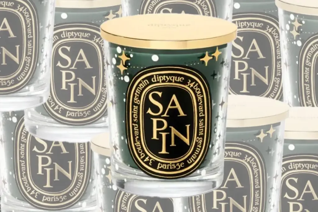 sapin candle from diptyque shown in front of array of other sapin candles