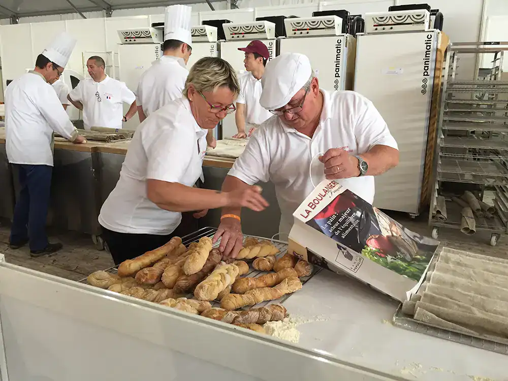 la fete du pain - two workers organizing bread