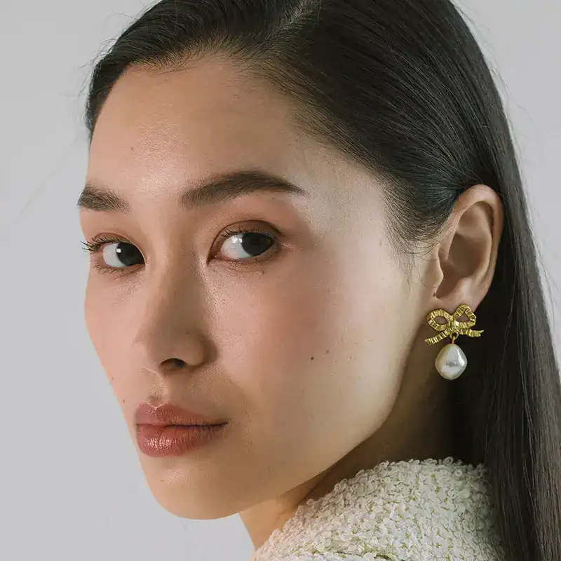 jennifer behr golden and pearl khloe earrings shown on model