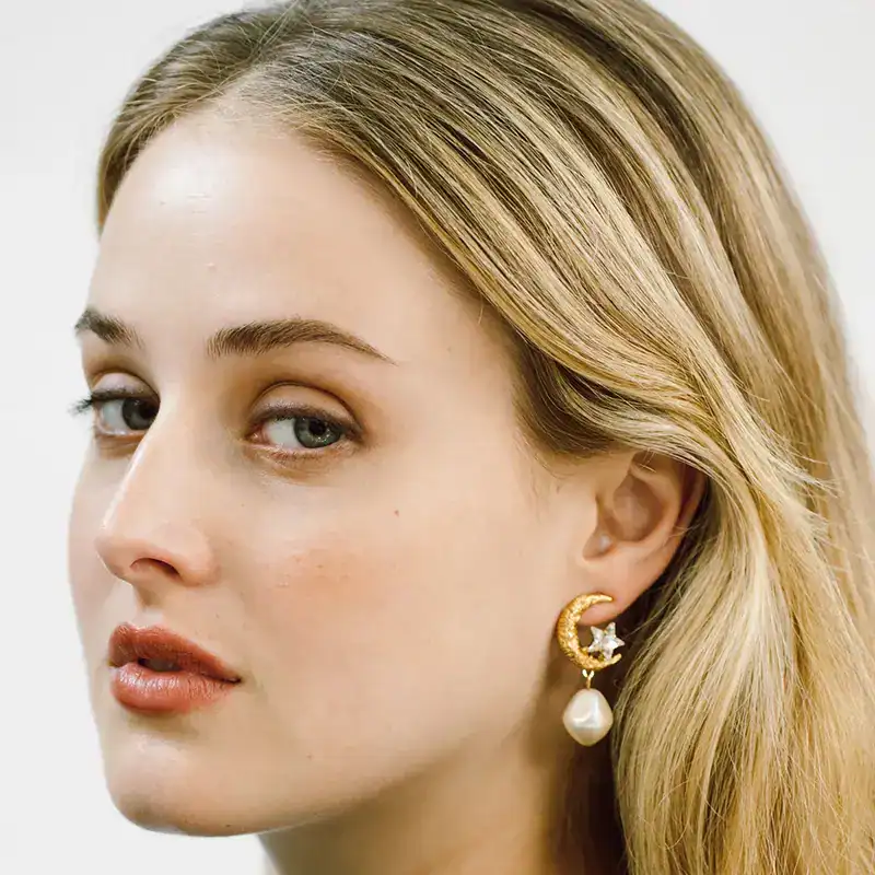 jennifer behr crystal and golden lune earrings shown on model