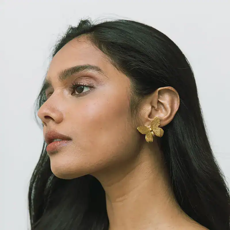 jennifer behr golden butterfly pyper earrings shown on model