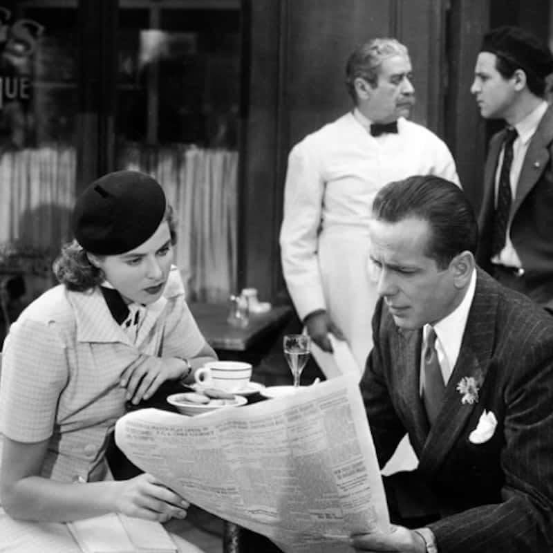 a vintage image of a couple sharing a newspaper from casablanca